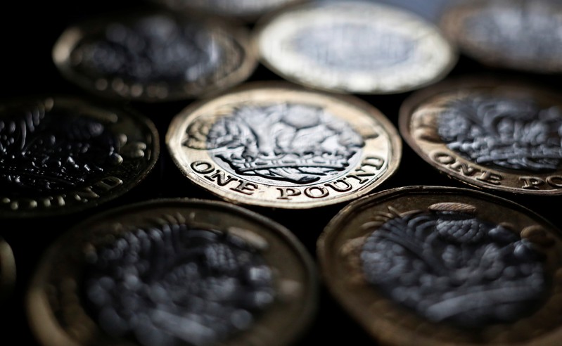 Pound coins are seen in the photo illustration taken in Manchester, Britain