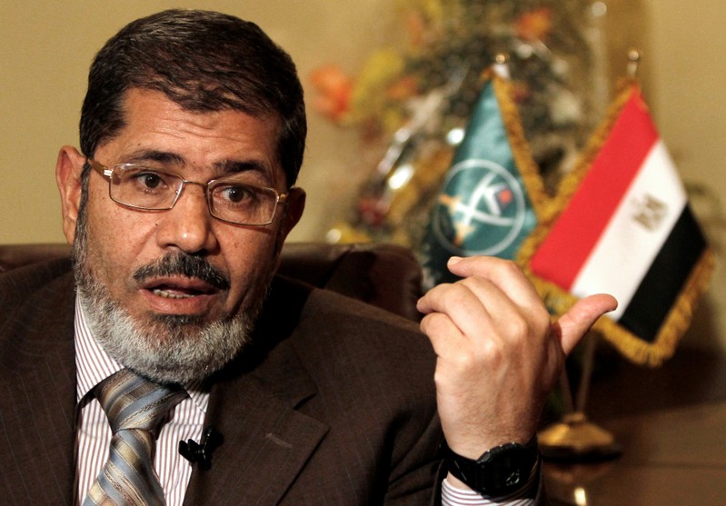 FILE PHOTO - Mohamed Mursi, head of the Brotherhood's newly formed Justice and Freedom Party gestures during an interview with Reuters in Cairo