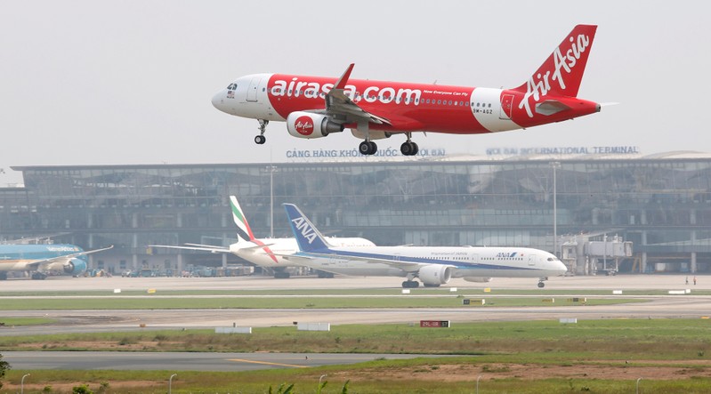 FILE PHOTO: An AirAsia Airbus A320 prepares to land at Noi Bai international airport in Hanoi