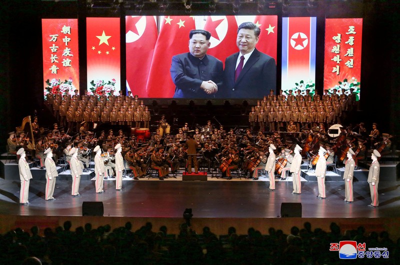 An image of North Korean leader Kim Jong Un and China's President Xi Jinping is displayed during a North Korean delegation's visit in Beijing