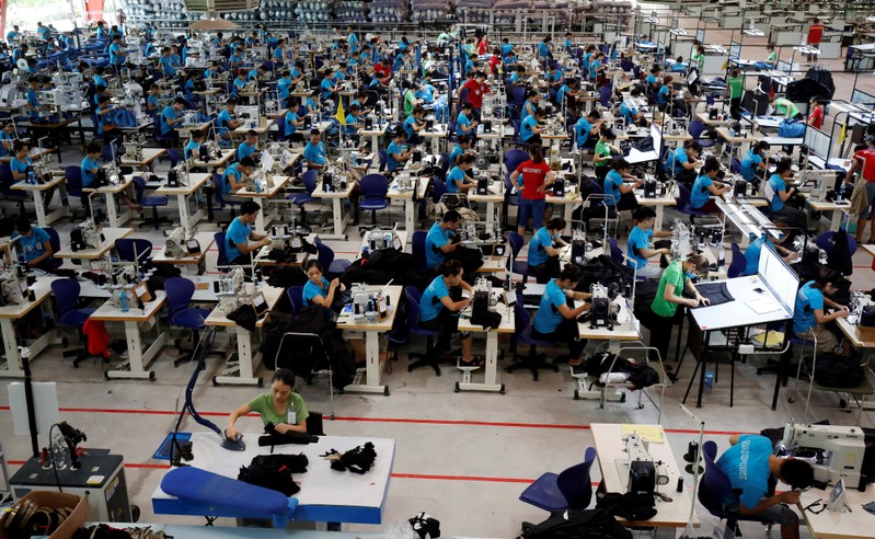 FILE PHOTO: Labourers work at Maxport garment factory in Thai Binh province