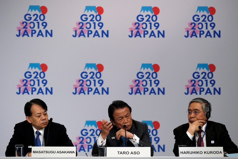 FILE PHOTO: Japanese Vice Minster of Finance Asakawa, Finance Minister Aso, and Bank of Japan Governor Kuroda hold a news conference at the IMF and World Bank's 2019 Annual Spring Meetings, in Washington