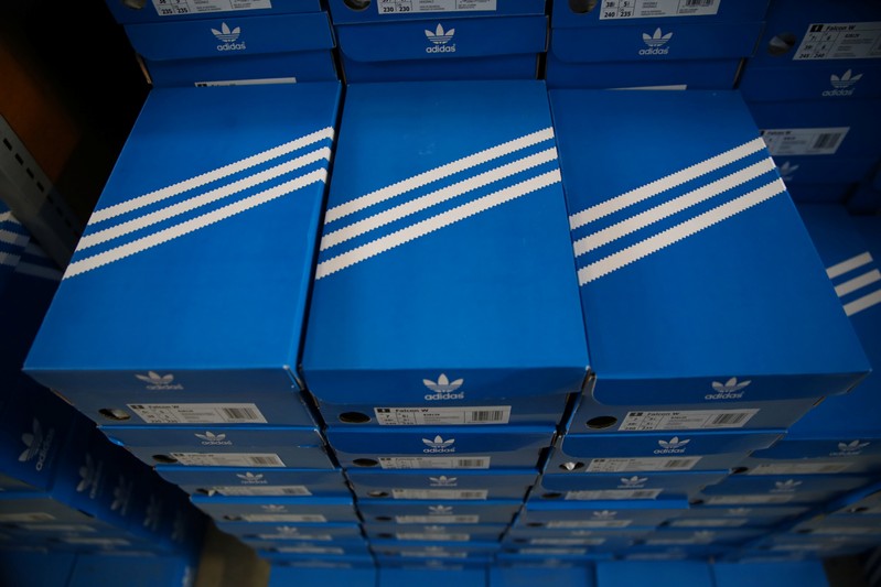 Boxes of Adidas shoes are pictured in the warehouse of local footwear retailer