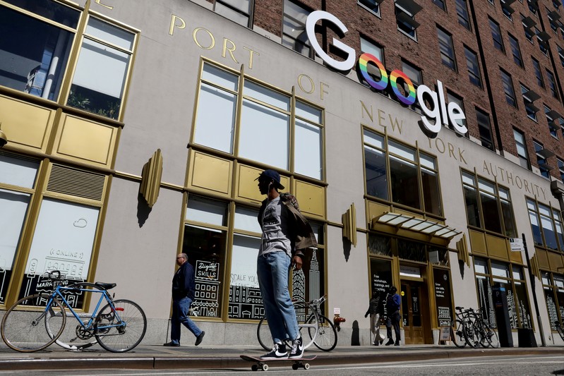 FILE PHOTO: People pass by an entrance to Google offices in New York