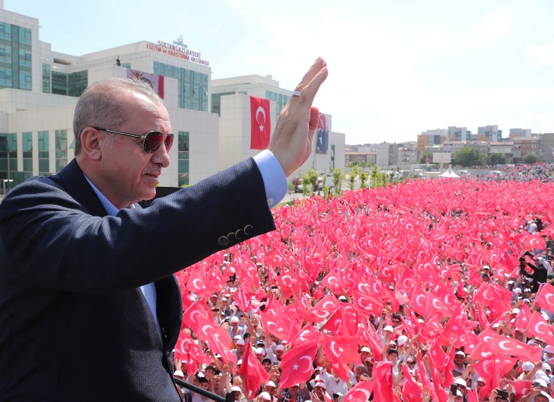 Turkish President Erdogan greets his supporters during an opening ceremony in Istanbul