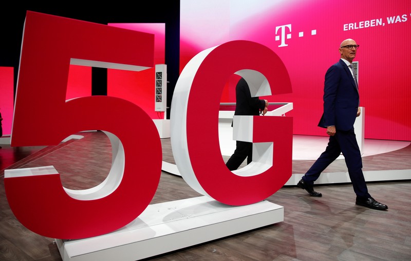 FILE PHOTO: Tim Hoettges, CEO of Deutsche Telekom AG walks on stage for the company's AGM in Bonn