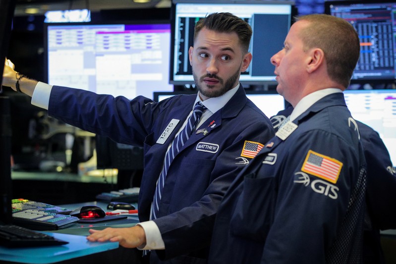 Traders work on the floor at the NYSE in New York