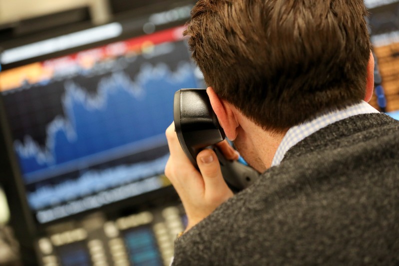 FILE PHOTO: A broker looks at a graph on his computer screen on a dealing floor in London, Britain