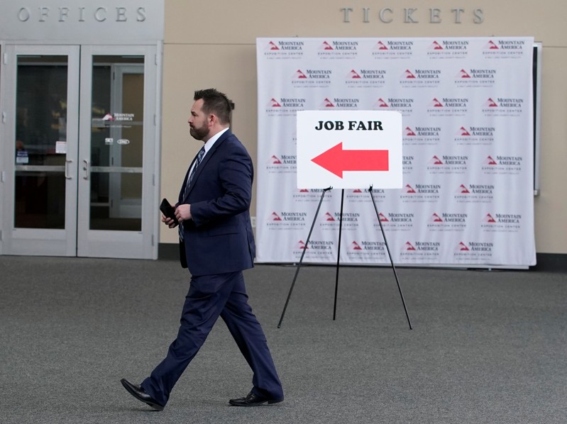 FILE PHOTO: A man walks into register at a job fair in Sandy, Utah