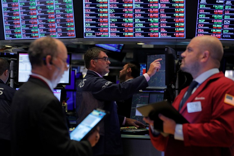 Traders work on the floor at the NYSE in New York