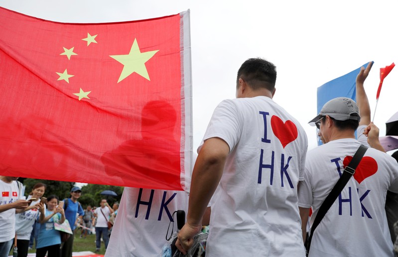 Pro-government supporters attend a rally to support the police and call for an end to violence in Hong Kong