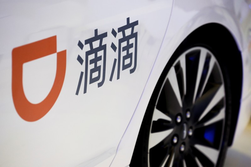 FILE PHOTO: The company logo of ride hailing company Didi Chuxing is seen on a car door at the IEEV New Energy Vehicles Exhibition in Beijing