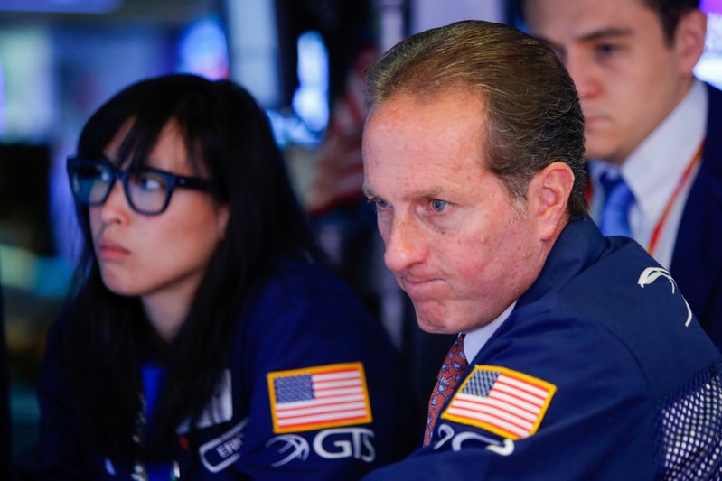 Traders work on the floor at the New York Stock Exchange (NYSE) in New York