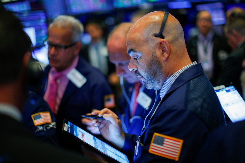 Traders work on the floor at the New York Stock Exchange (NYSE) in New York