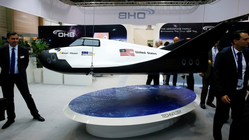 FILE PHOTO: Visitors watch the Dream Chaser Cargo System developed by Sierra Nevada Corporation Space Systems at the ILA Berlin Air Show in Schoenefeld