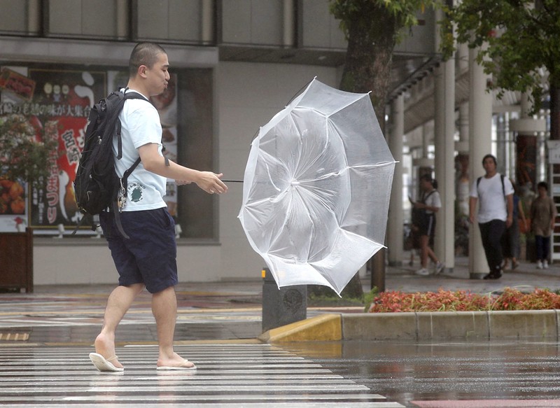 A man makes his way amid strong wind by typhoon Krosa in Miyazaki