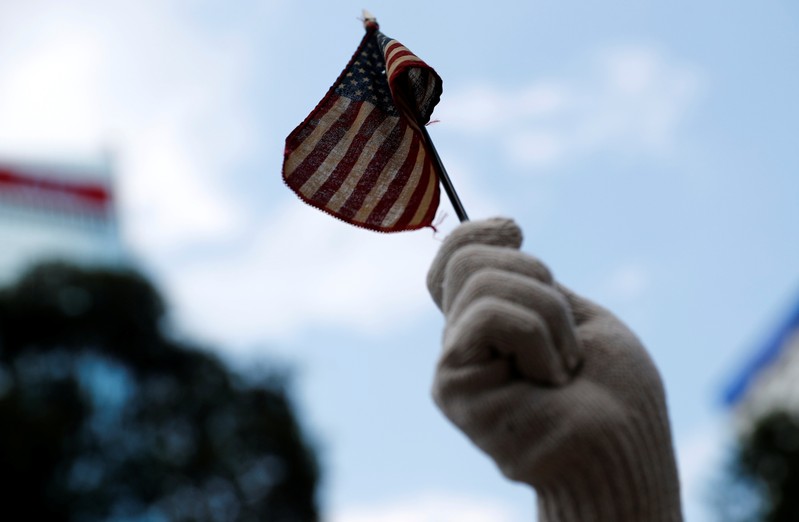 A protester holds a U.S. flag in Central, Hong Kong