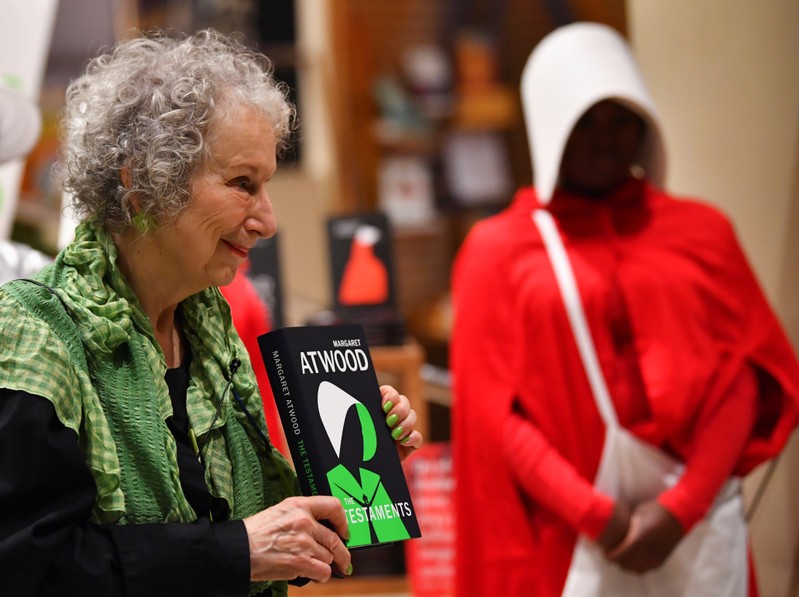 Author Margaret Atwood holds up her new novel The Testaments during the launch at a book store in London, Britain
