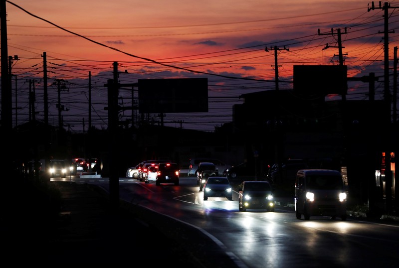 Cars drive past during a blackout caused by Typhoon Faxai in Kisarazu, Chiba prefecture