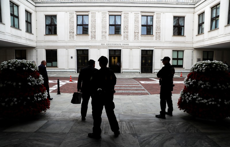 Security guards of Parliament stands outside the building of Parliament in Warsaw