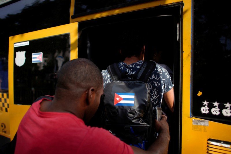 People board a public bus in Havana