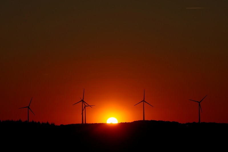 FILE PHOTO: Power-generating windmill turbines are pictured during sunset at a wind park in Campeneac