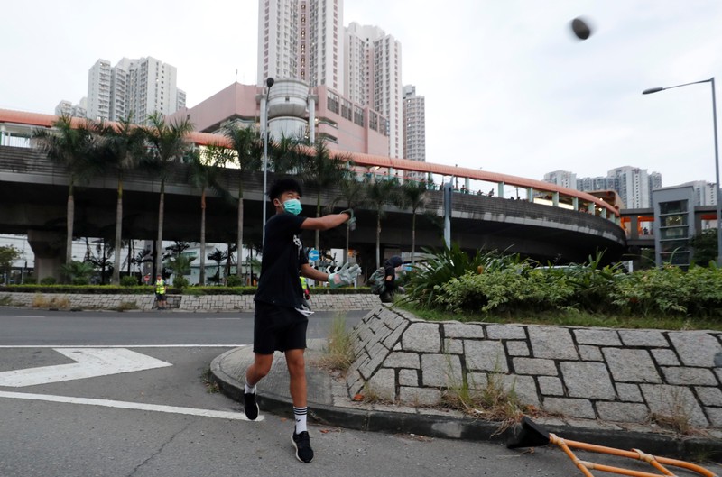 A demonstrator throws a stone in Tin Shui Wai in Hong Kong