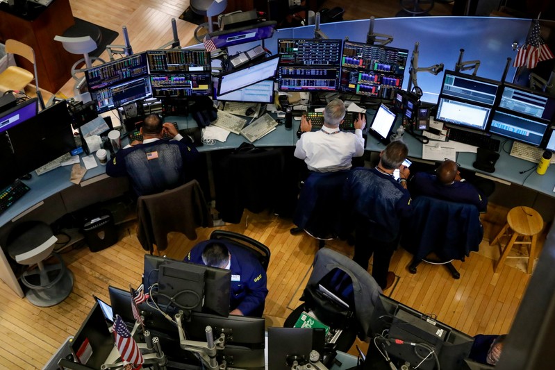 Traders work on the floor at the NYSE in New York