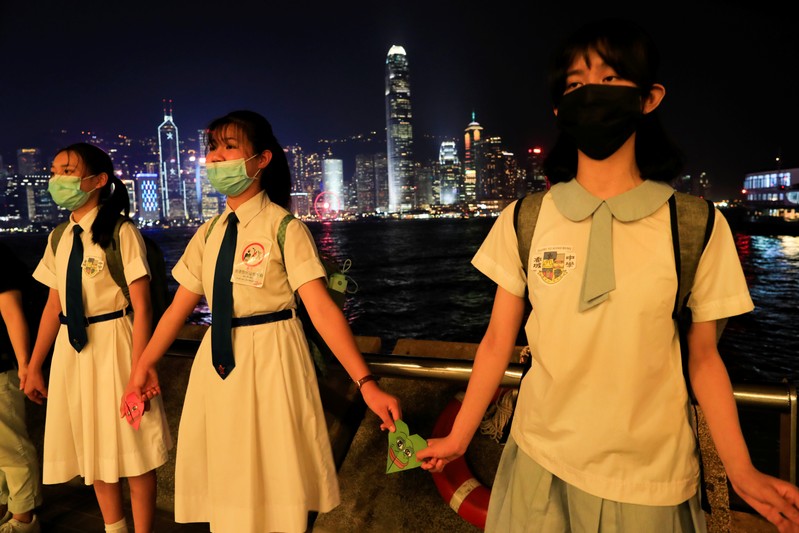 Anti-government protesters make a human chain in the harbour area in Hong Kong