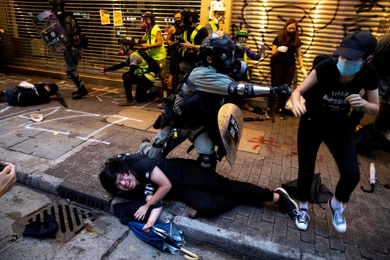 Riot police officers clash with anti-government protesters during a demonstration in Causeway Bay district in Hong Kong