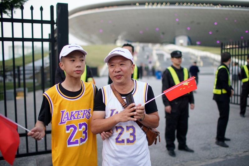 Fans in LeBron James jerseys hold Chinese flags outside the Mercedes-Benz Arena before the NBA exhibition game between Brooklyn Nets and Los Angeles Lakers in Shanghai