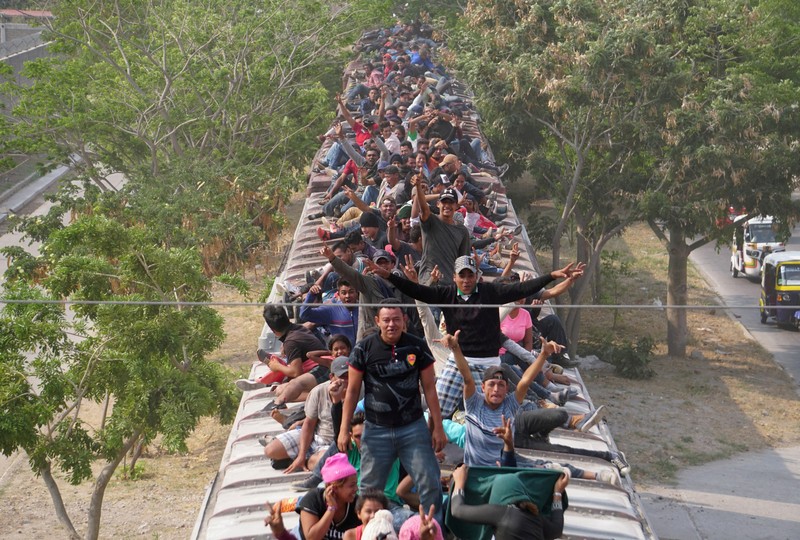 FILE PHOTO: Central American migrants ride train through Juchitan, Oaxaca