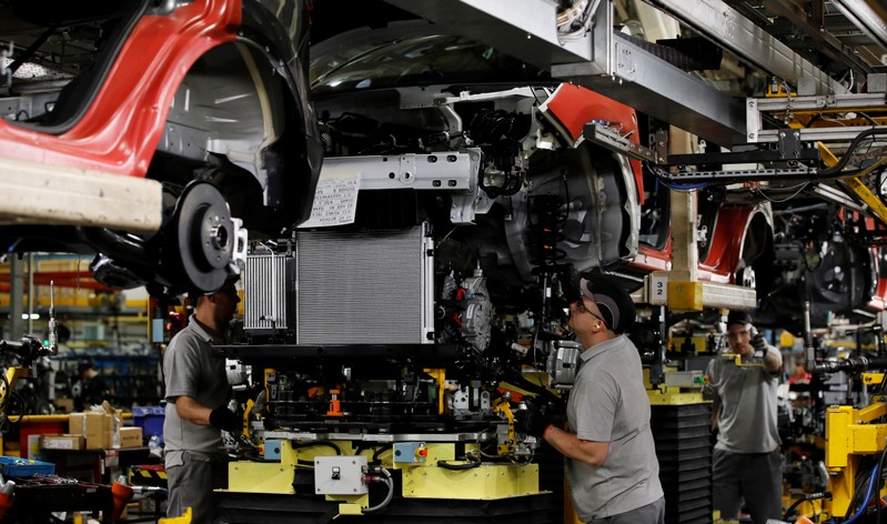 Workers are seen on the production line at Nissan's car plant in Sunderland Britain