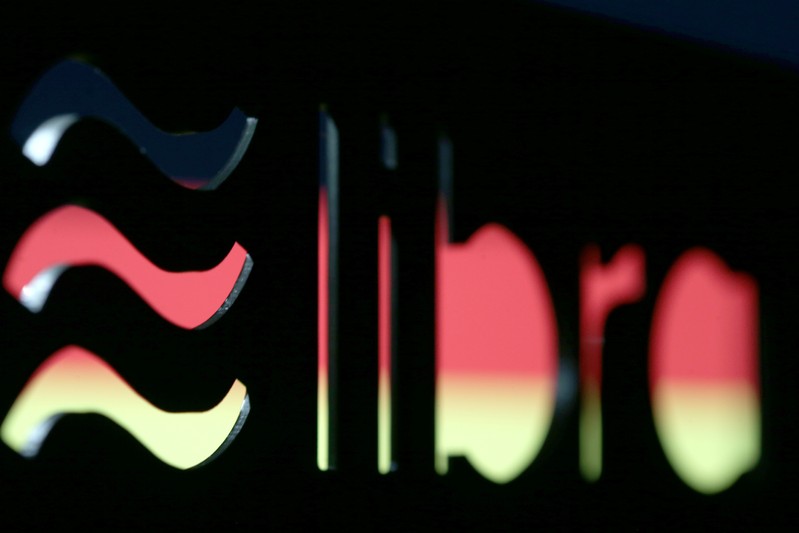 A 3D-printed Facebook Libra cryptocurrency logo is seen in front of displayed German flag in this illustration taken
