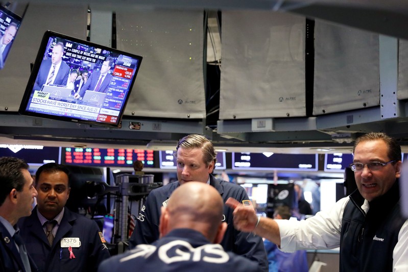 Traders work on the floor of the New York Stock Exchange shortly after the opening bell in New York