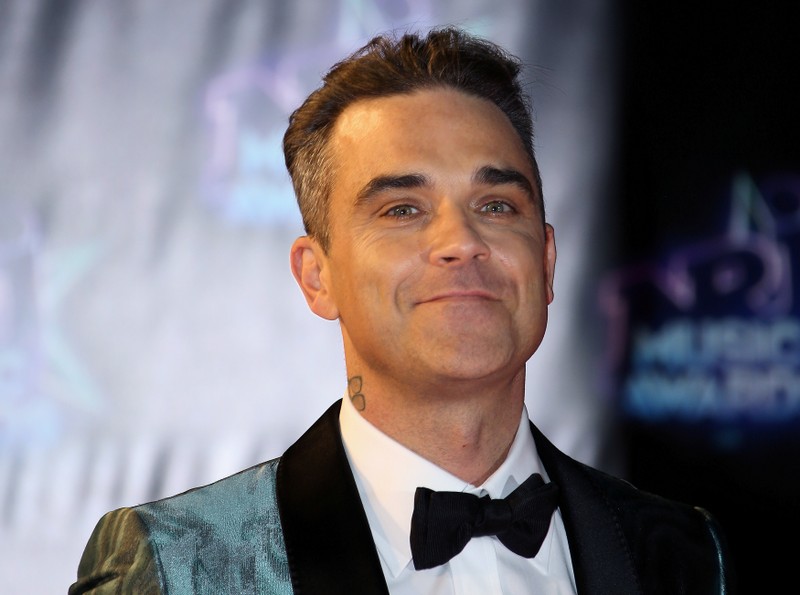 Singer Robbie Williams arrives to attend the NRJ Music Awards ceremony at the Festival Palace in Cannes