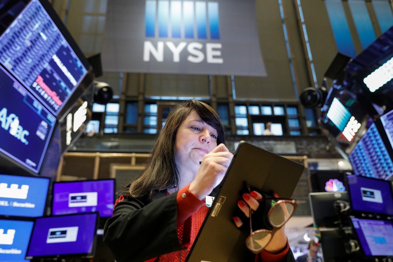 FILE PHOTO: A trader works on the floor at the NYSE in New York