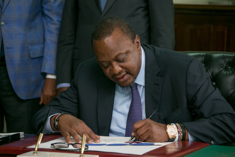 FILE PHOTO: Kenya's President Uhuru Kenyatta signs into law the Finance Bill 2019 at State House in Nairobi