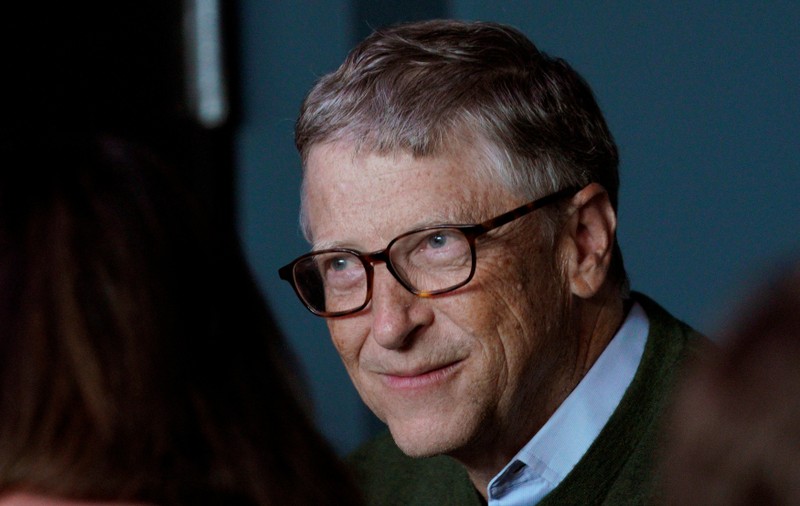 FILE PHOTO: Microsoft founder Bill Gates smiles while playing bridge with Warren Buffett, CEO of Berkshire Hathaway Inc, as part of the company annual meeting weekend in Omaha