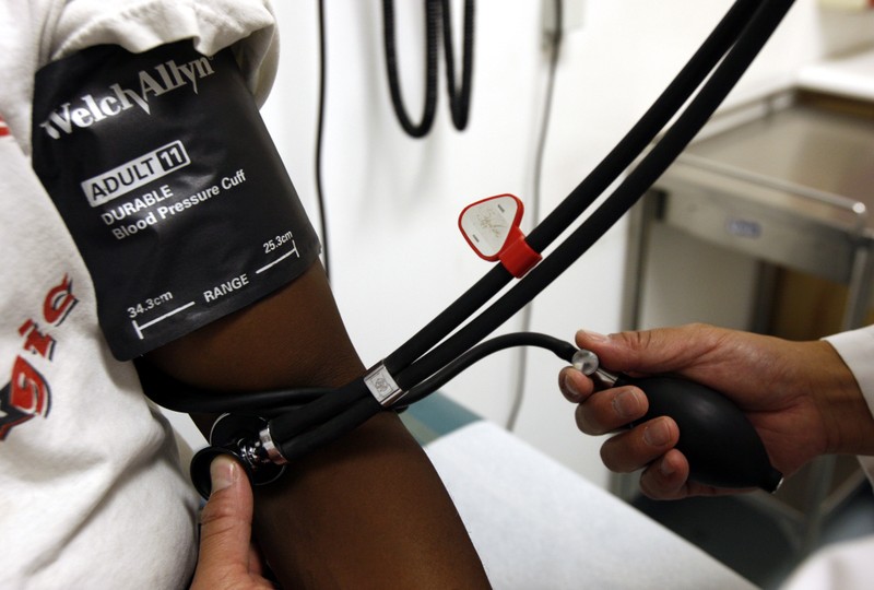 FILE PHOTO: A doctor checks the blood pressure of a patient at the J.W.C.H. safety-net clinic in downtown Los Angeles