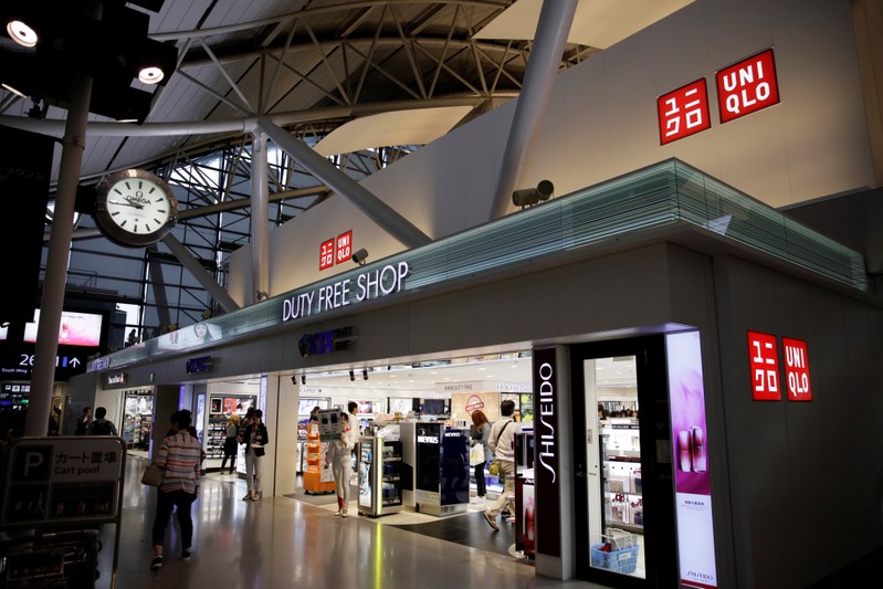 FILE PHOTO: People shop at a UNIQLO by Fast Retailing store at Kansai International Airport in Osaka