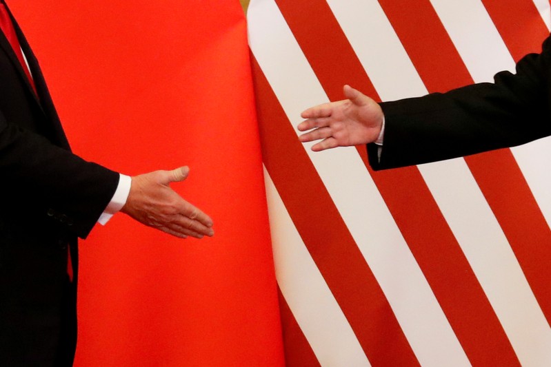 FILE PHOTO: U.S. President Donald Trump and China's President Xi Jinping shake hands after making joint statements at the Great Hall of the People in Beijing