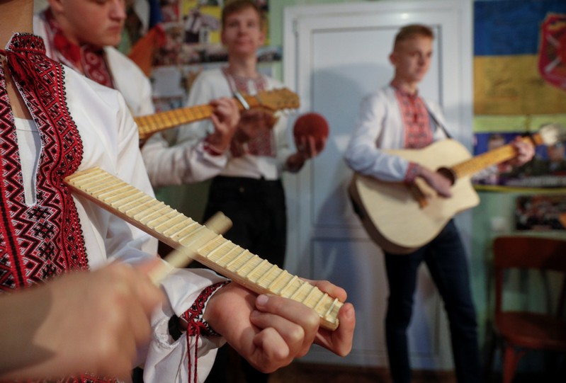 Members of a musical band play instruments made of safety matches during a rehearsal in Zhashkiv