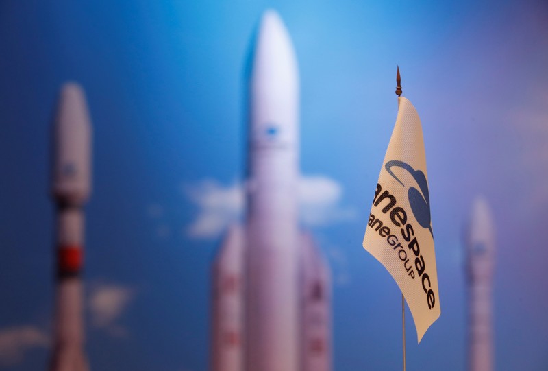 FILE PHOTO: A flag with a company logo is seen during satellite launch company Arianespace annual news conference in Paris