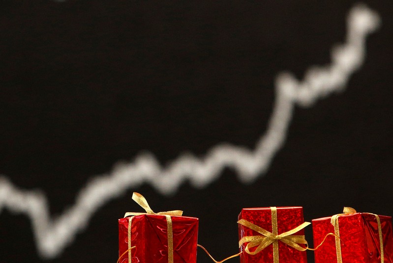 FILE PHOTO: Christmas decoration is pictured in front of the German share price index DAX board at the German stock exchange in Frankfurt
