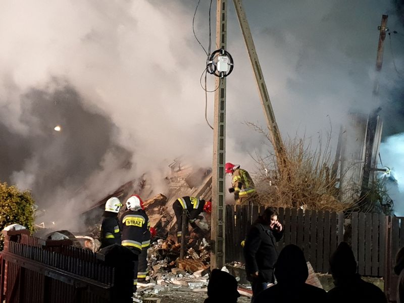 Firefighters work at the site of a building levelled by a gas explosion in Szczyrk
