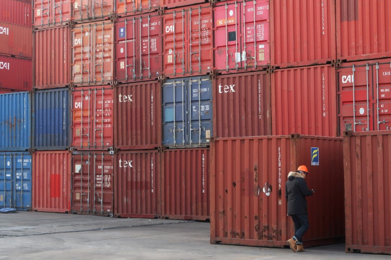 Worker checks containers at a logistics center near Tianjin port