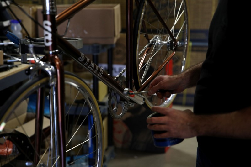 Gabe Ortiz services one of the company's products at State Bicycle in Tempe