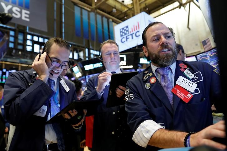 Traders work on the floor at the NYSE in New York