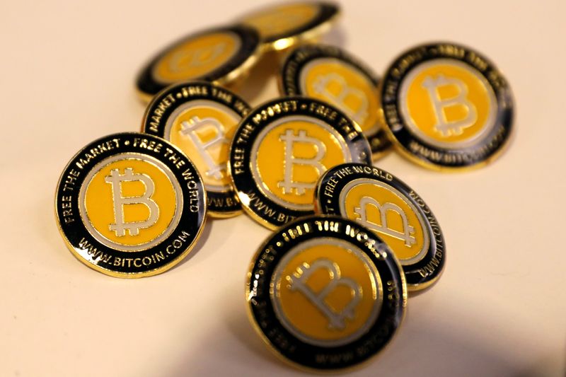 Bitcoin.com buttons are seen displayed on the floor of the Consensus 2018 blockchain technology conference in New York City